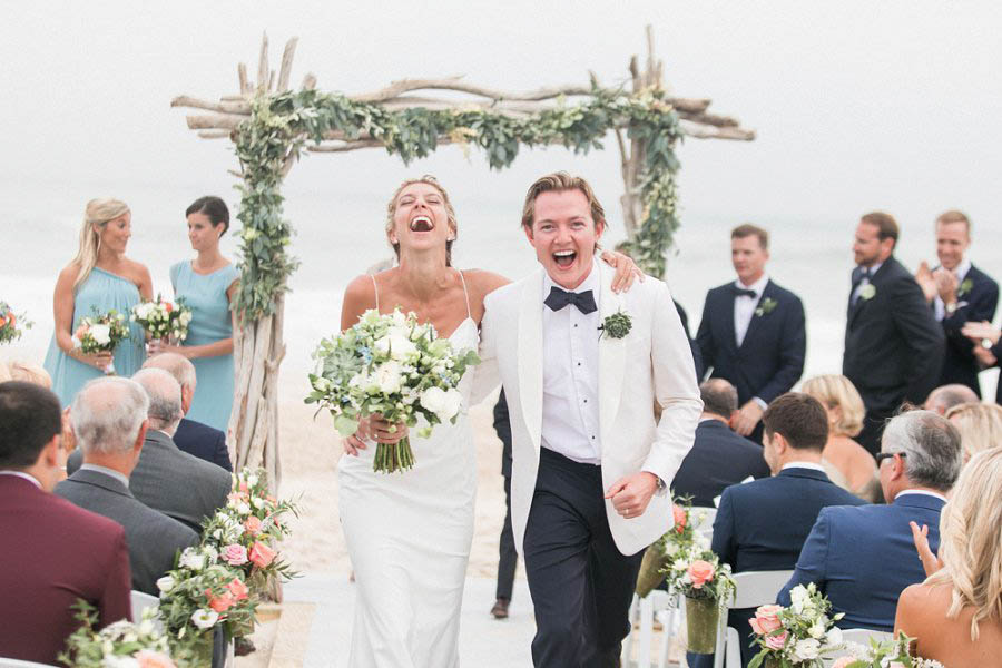 Bride and groom at beach ceremony at Bridgehampton Tennis and Surf Club, pictured by destination wedding photographer Amy Rizzuto.