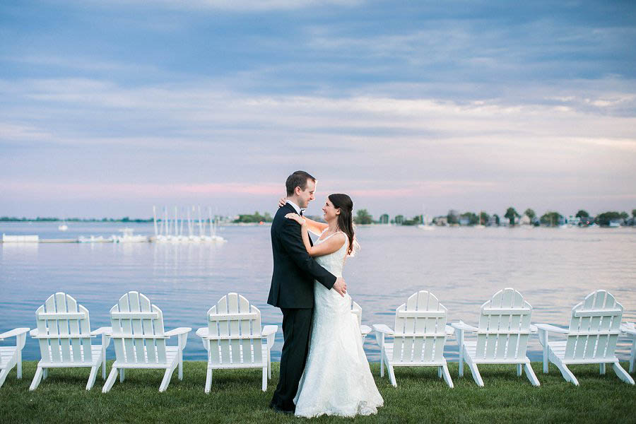Bride and groom embrace during The Inn at Longshore wedding day in photo by Connecticut wedding photographer Amy Rizzuto