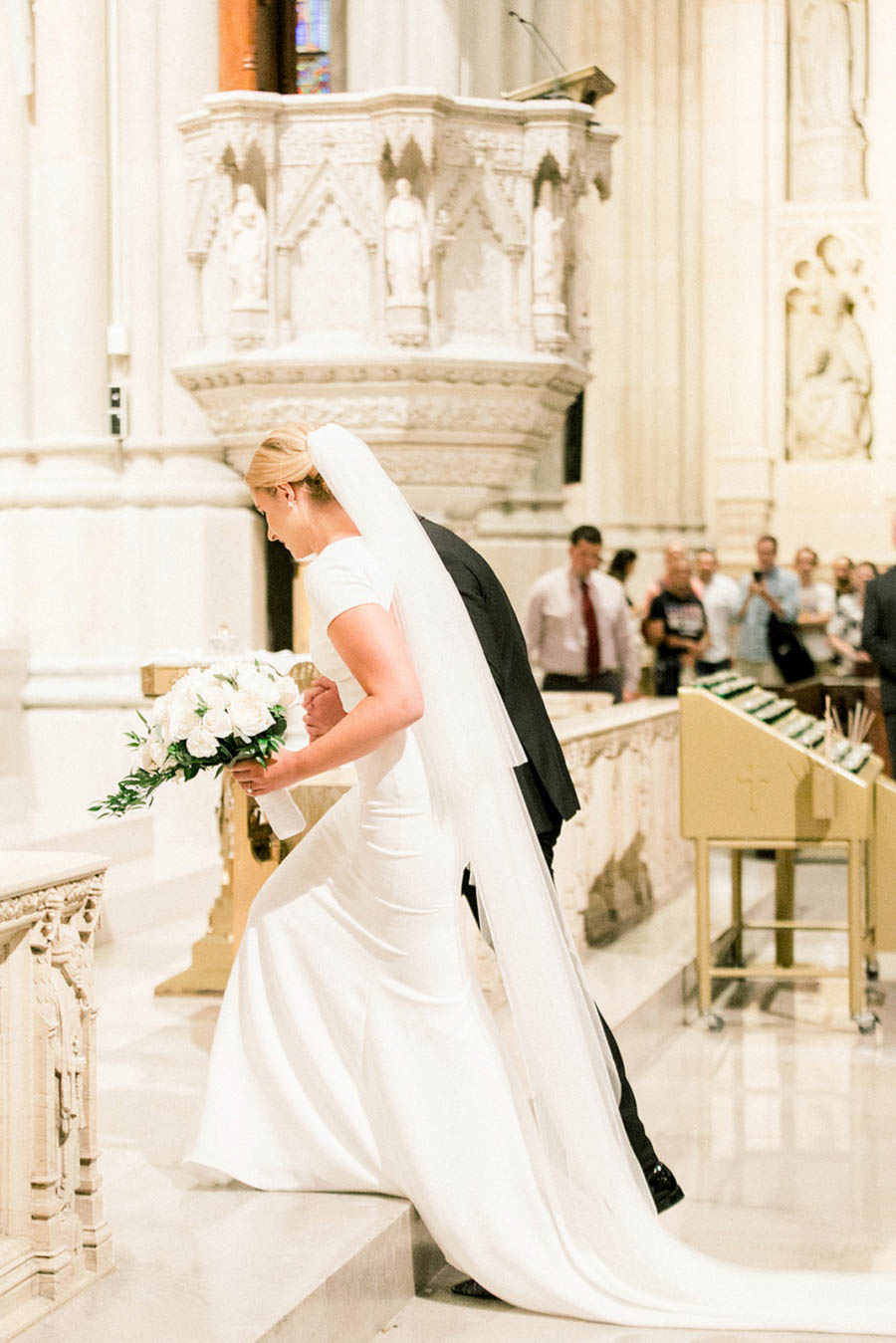 Margaret and Ryan enter their St. Patrick's Cathedral wedding ceremony in this photo by New York wedding photographer Amy Rizzuto.