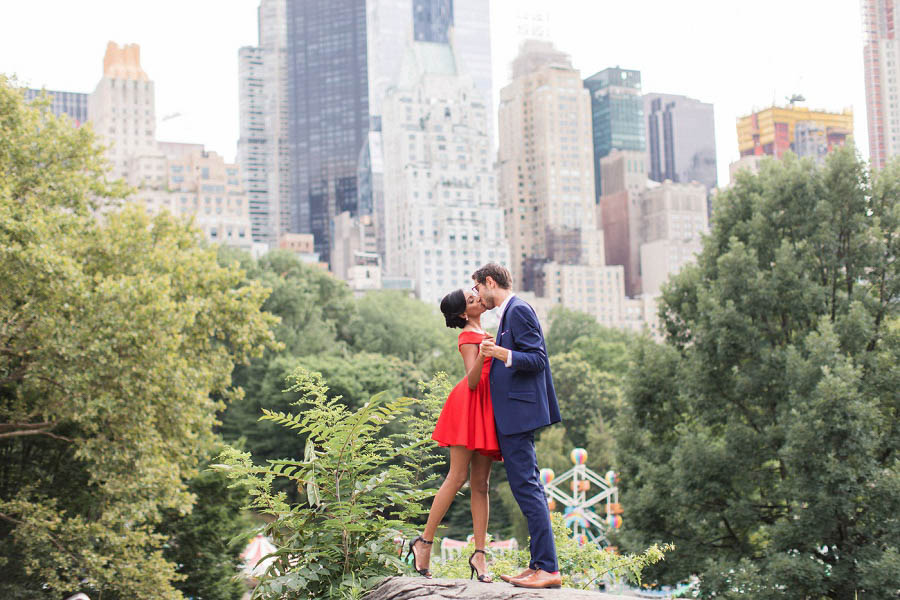 NYC engagement photographer, Amy Rizzuto of Amy Rizzuto Photography, captures Central Park engagement photos of Minoli and Joe posing in front of the city skyline