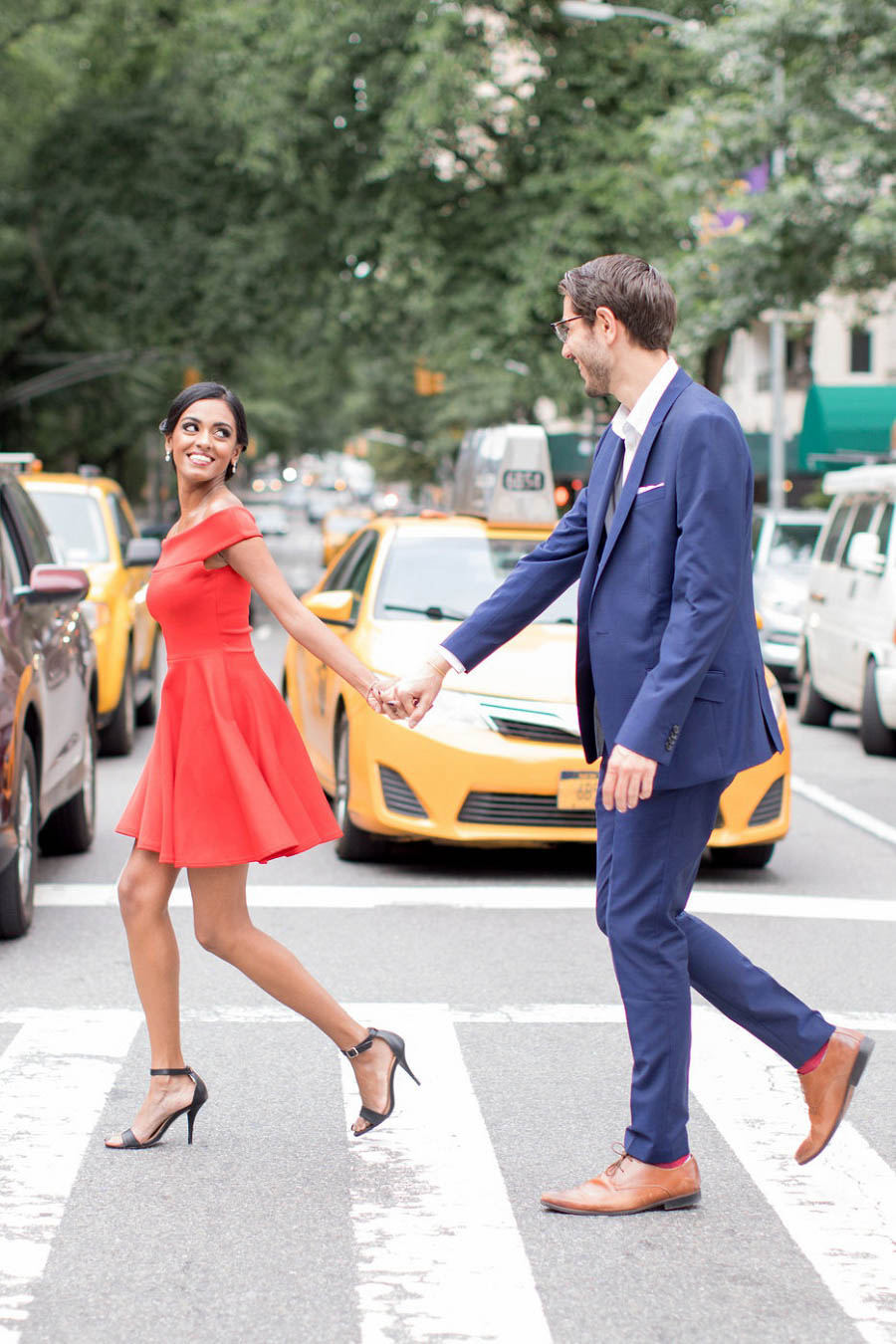 Couple crosses busy NYC street in this NYC engagement photo by NYC engagement photographer Amy Rizzuto