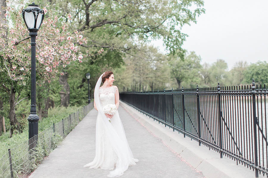 Emily poses for her cherry blossom bridal portraits at the Brooklyn Botanical Garden in NYC, photo by NYC wedding photographer Amy Rizzuto.