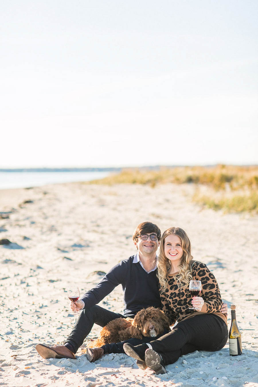 Beach engagement photo by Hamptons wedding photographer Amy Rizzuto Photography. Adorable engagement photo with dogs
