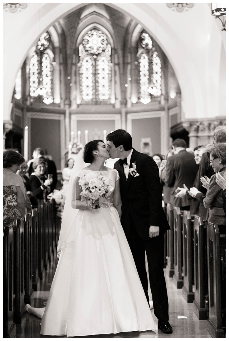 Bride and groom black and white kiss wedding ceremony