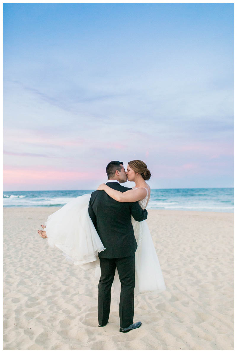 Sunset beach wedding photo at Spring Lake Bath and Tennis Club wedding captured by best NJ wedding photographer Amy Rizzuto Photography