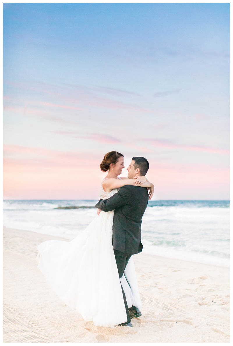Sunset beach wedding photo at Spring Lake Bath and Tennis Club wedding captured by best NJ wedding photographer Amy Rizzuto Photography