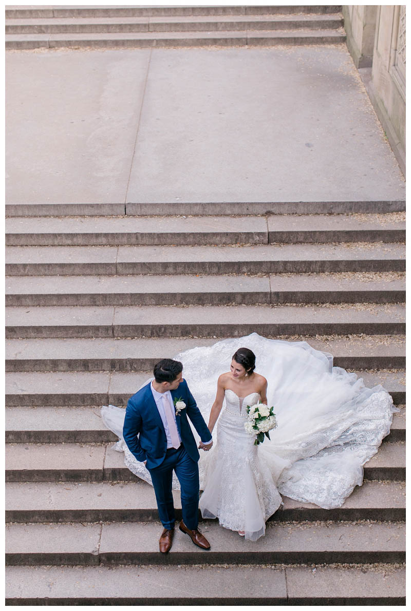 Bride and groom on bethesda terrace steps in Central Park wedding photo captured by best Central Park wedding photographer Amy Rizzuto Photography