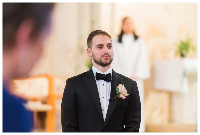 emotional groom watches beautiful bride come down the aisle
