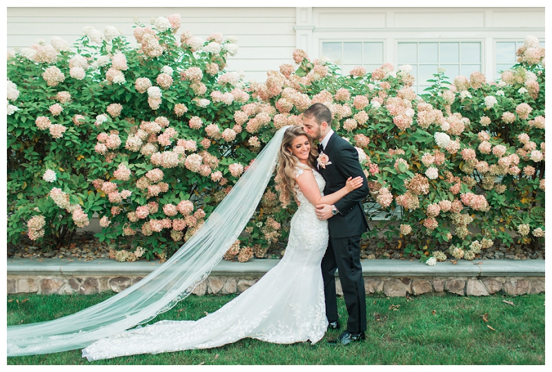 bride and groom floral backdrop at ryland inn wedding