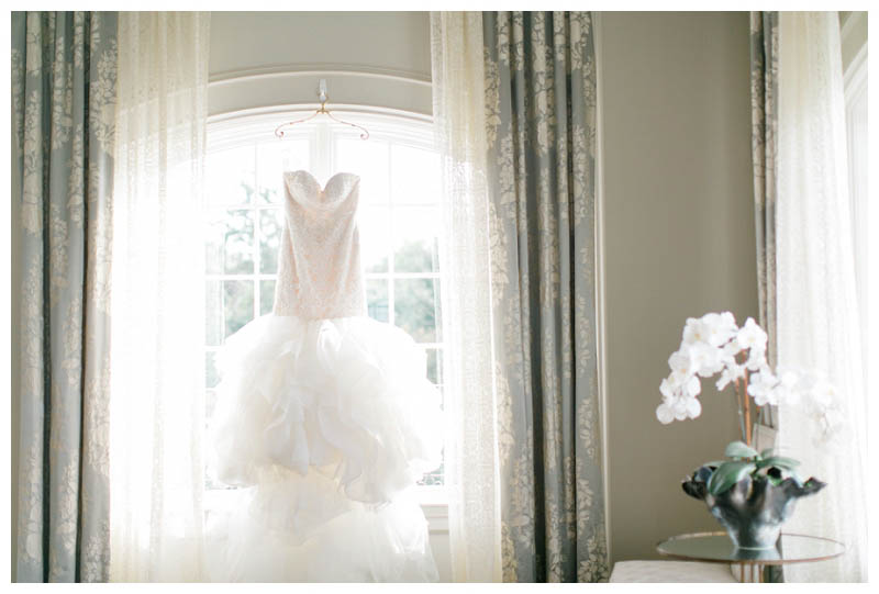 wedding dress hanging from bright window