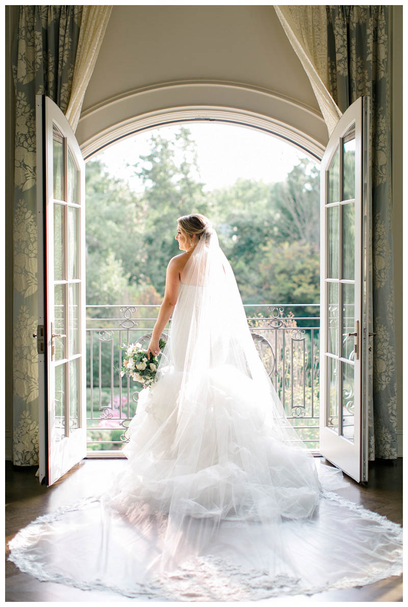 Bride on balcony at Park Chateau wedding captured by Amy Rizzuto Photography