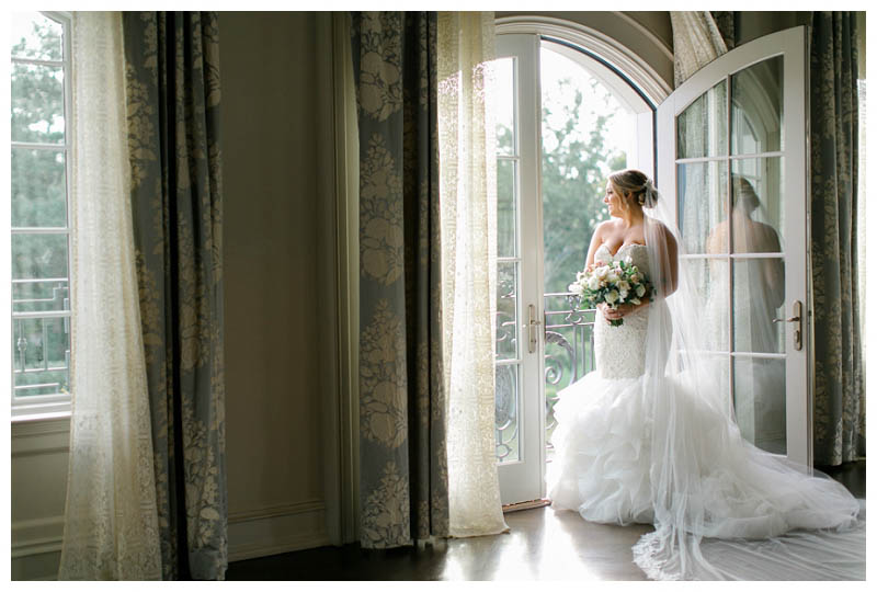 Bride looking out window on wedding day
