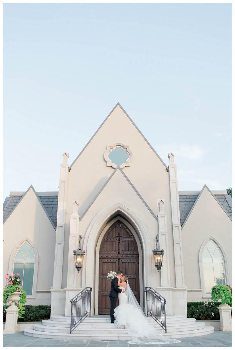 bride and groom kiss outside chapel