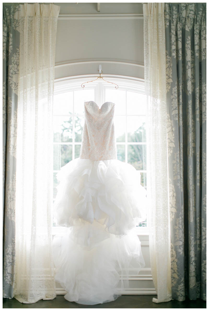 wedding dress hanging from window Park Chateau wedding captured by Amy Rizzuto Photography