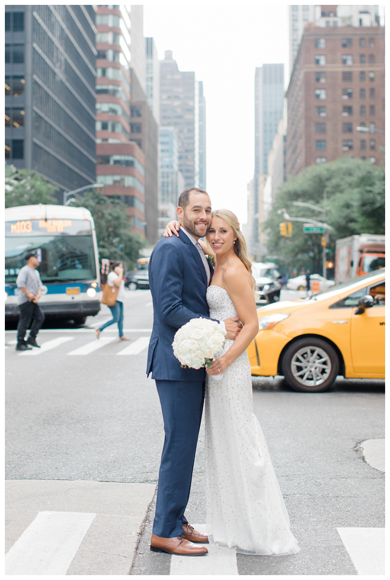 bride and groom on wedding day in nyc with yellow cab