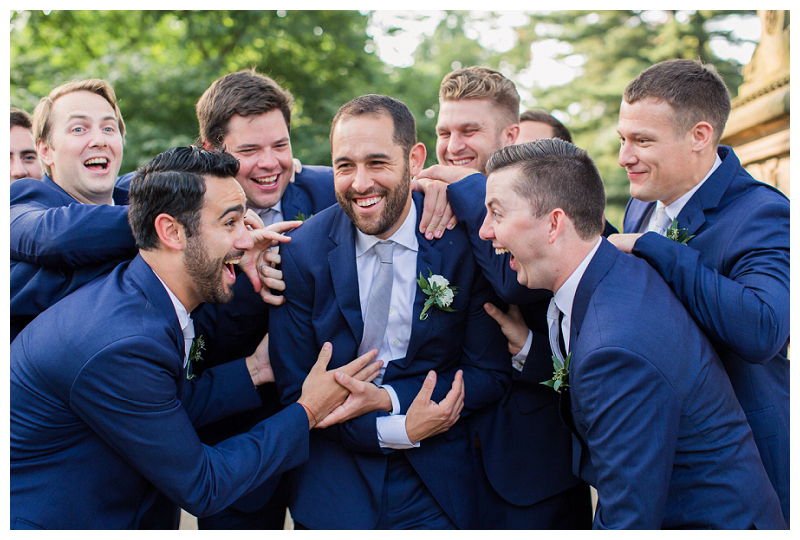 groomsmen in central park laughing