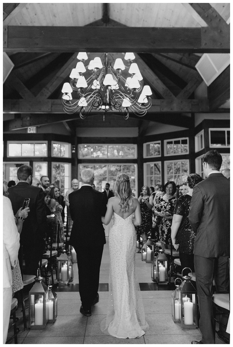black and white bride walking down aisle with father
