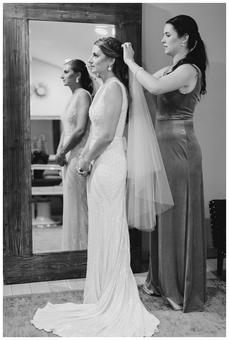 Bride getting dressed black and white photo idea