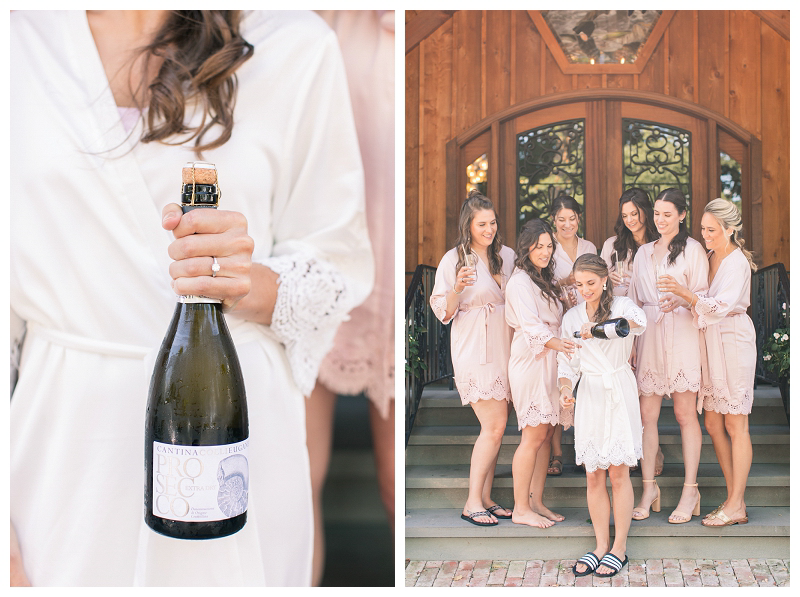 Bride popping champagne with bridesmaids in pink robes