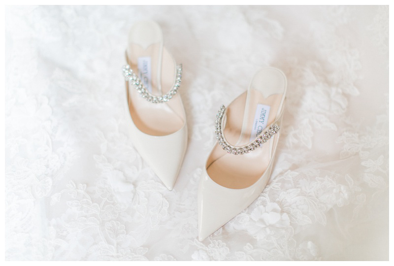Jimmy Choo wedding shoes on lace background captured by NYC luxury wedding photographer Amy Rizzuto Photography