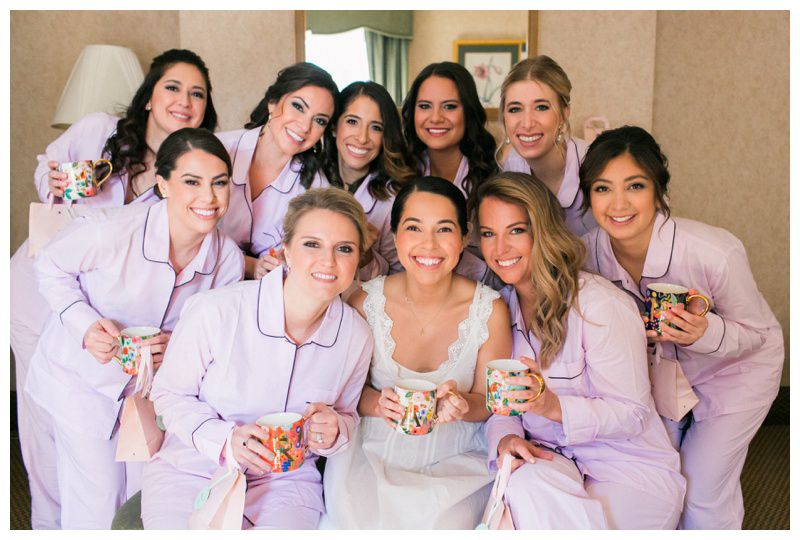 bride getting ready with bridesmaids in light purple pajamas winter bridesmaid getting ready outfits