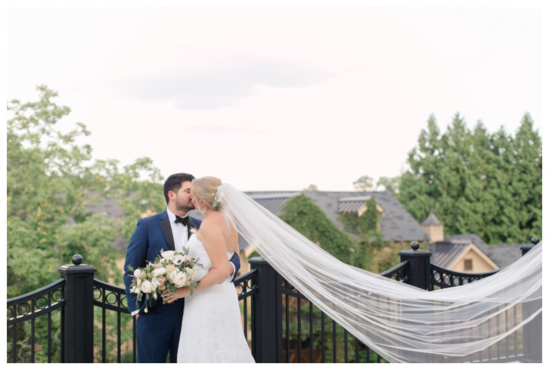 Groom kisses bride on terrace of Ashford Estate wedding