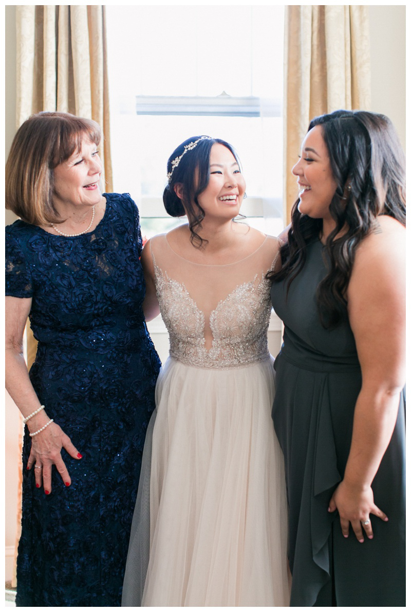 Happy bride with mom and sister on wedding day