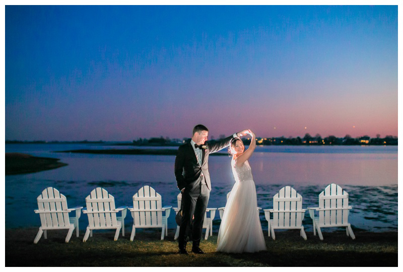 Groom twirls bride in Sunset wedding photo at The Inn at Longshore wedding captured by Amy Rizzuto Photography